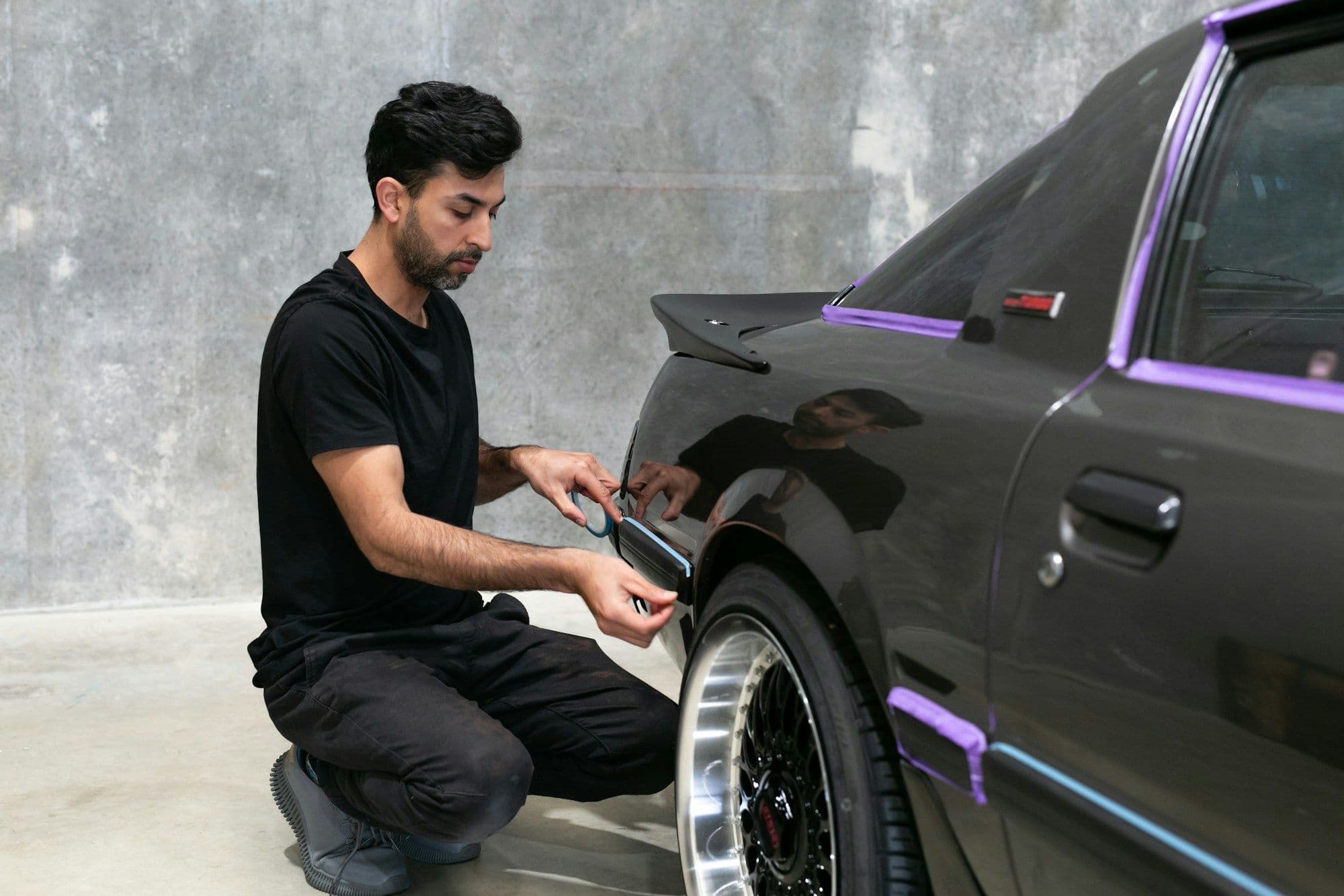 Technician working on a car's paint finish