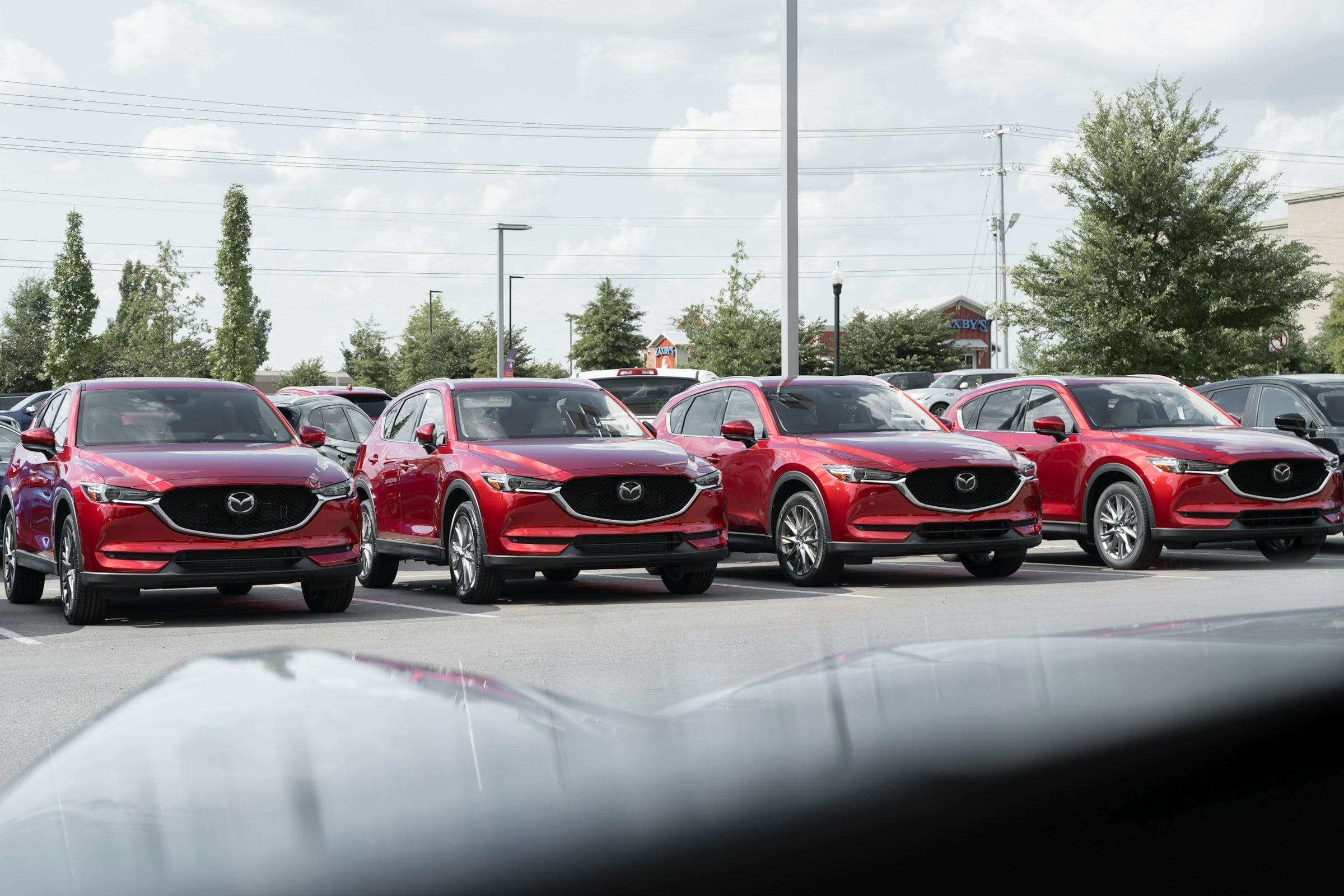 Row of identical SUVs on a dealer lot