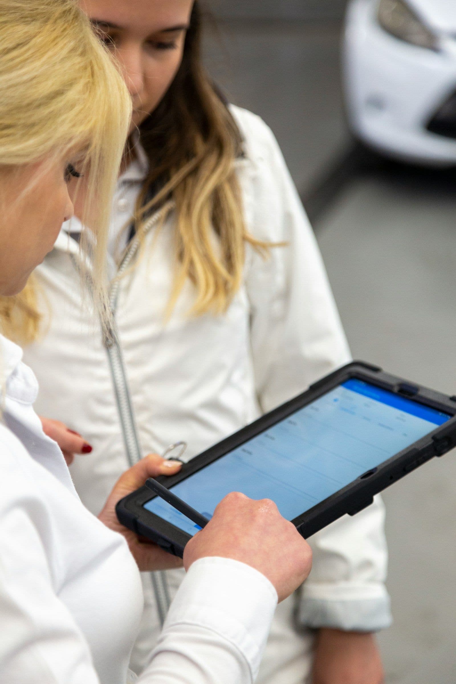 Two women reviewing information on a tablet